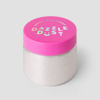 A clear jar with a bright pink lid shows Jenna Rae Cakes Diamond Edible Glitter in bold, colorful letters on a plain gray background, and is filled with white powder.