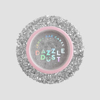 A round Jenna Rae Cakes Disco Ball Edible Glitter 5g shaker with a pink rim holds shiny silver edible glitter. It comes in a package of 6, and the iridescent, multicolored label stands out against a light grey background.