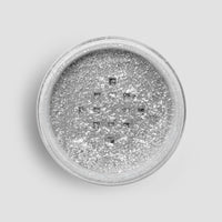 A round 5g shaker of Jenna Rae Cakes Disco Ball Edible Glitter, filled with loose, sparkling silver powder, viewed from above against a light gray background. Sold as a package of 6.