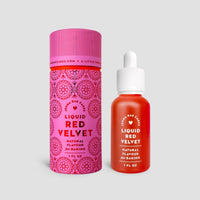 A small dropper bottle of Jenna Rae Cakes Liquid Red Velvet – Package of 6, stands beside its matching pink and red floral cylindrical packaging, both set against a light gray background.