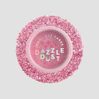 A round Jenna Rae Cakes Lollipop Edible Glitter 5g Shaker (pack of 6), filled with pink edible glitter, sits on a light gray background surrounded by chunky pink glitter.
