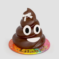 The One-of-a-Kind Cakes by Jenna Rae Cakes features a poop emoji shape with big eyes, a wide smile, and a white bow on top, set on a colorful star-patterned base personalized with the name “Lilani.”.