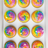 Rainbow Cupcakes by Jenna Rae Cakes: twelve cupcakes with vibrant rainbow swirled frosting and colorful sprinkles, arranged in three rows on a white tray.