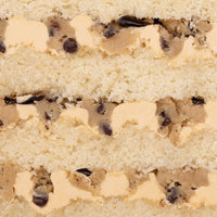Close-up of Jenna Rae Cakes Cookie Dough Cake, featuring layers of vanilla cake, cookie dough, chocolate chips, and creamy frosting.