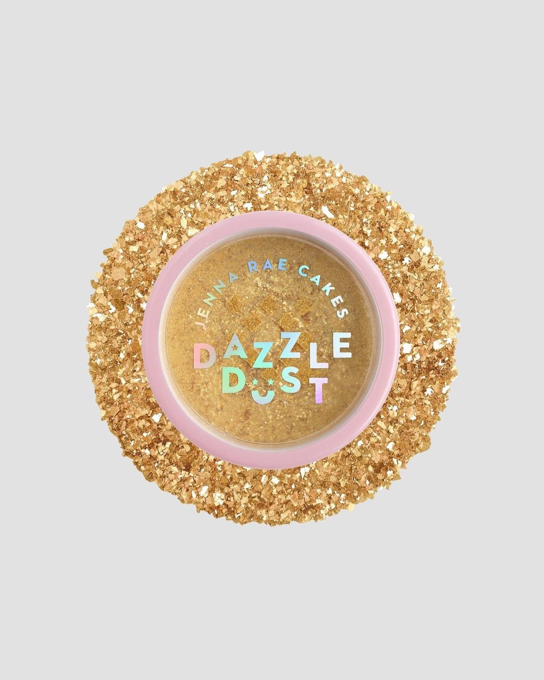 A round container of Jenna Rae Cakes FND TESTING - 24k Magic Edible Glitter (Copy), filled with gold edible glitter, is surrounded by loose gold glitter on a light grey background. The pink lid features colorful holographic text.