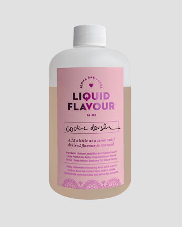 A 16 oz bottle of Jenna Rae Cakes Commercial Liquid Cookie Dough features a pink label with floral graphics, a white cap, and lists ingredients and usage directions.