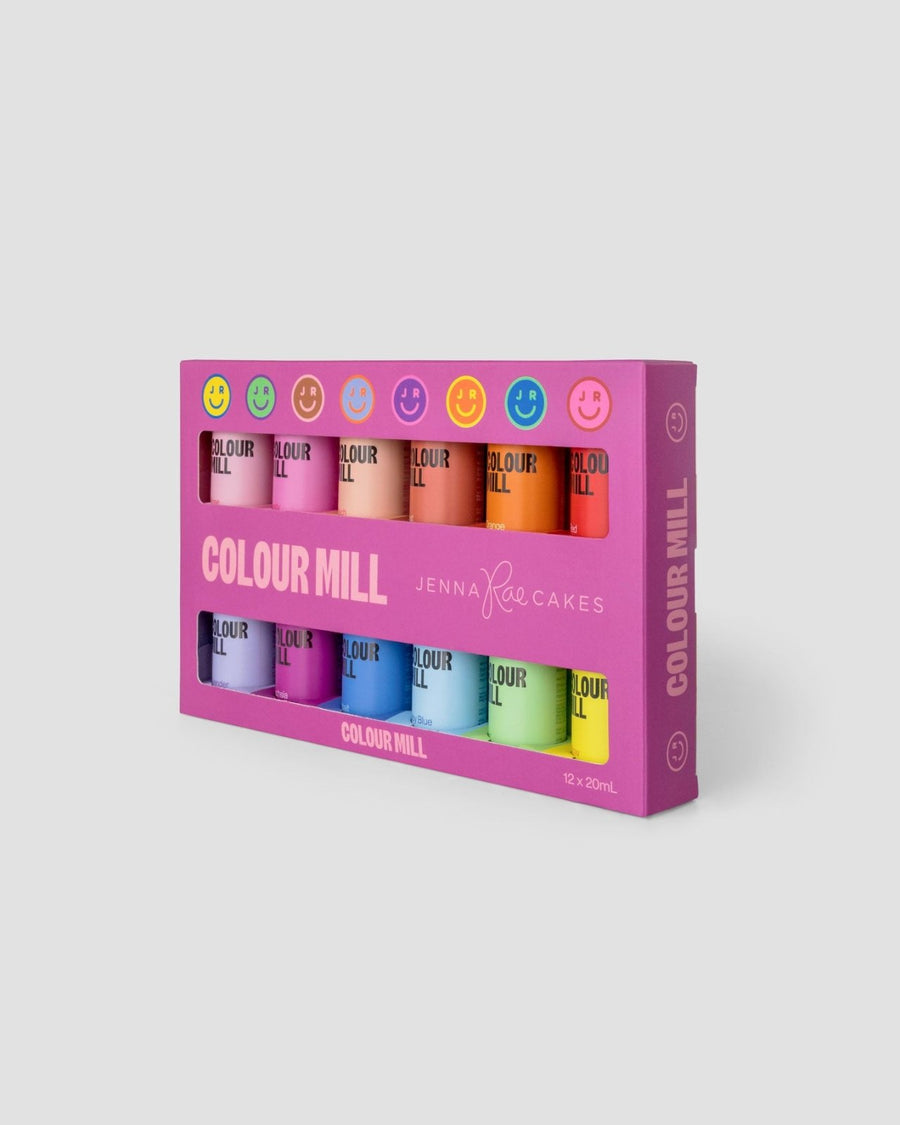 The Jenna Rae Cakes x Colour Mill Pack features twelve bright food coloring bottles in a purple box with colorful smiley faces and COLOUR MILL and Jenna Rae Cakes on the front.