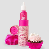 A package of 6 Jenna Rae Cakes Liquid Magic Mallow bottles stands upright next to pink cupcake liners, a pink lid labeled Jenna Rae Cakes, and a chocolate cupcake topped with pink frosting and mini marshmallows.