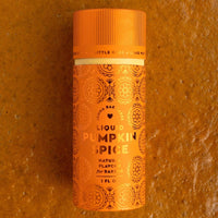A small orange bottle of Jenna Rae Cakes Liquid Pumpkin Spice (Package of 6) with decorative patterns stands upright on a textured orange surface.