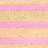 Close-up of the Reveal Works Cake by Shop Jenna Rae Cakes, featuring three layers of light yellow sponge with bright pink frosting between each layer, highlighting the cakes texture and vibrant colors.