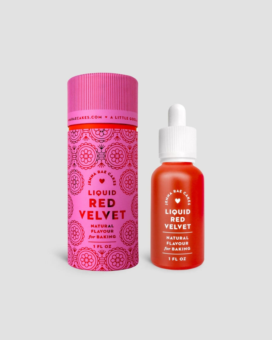 A 1 fl oz dropper bottle of Liquid Red Velvet by Jenna Rae Cakes is displayed beside its decorative pink and red cylindrical packaging on a light gray background.