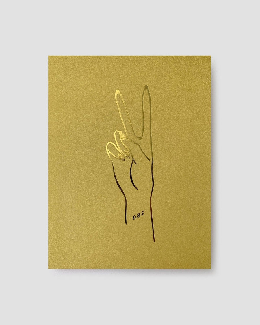 The Jenna Rae Cakes Peace Greeting Card features a minimalist line drawing of a hand making a peace sign, outlined in black and gold on a gold square background, with the number 088 near the wrist.