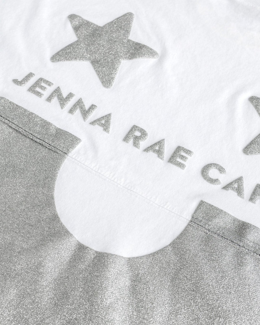 The Jenna Rae Cakes White and Silver Spirit Jersey features silver glittery stars, JENNA RAE CA text, and a large silver glitter semicircle on white fabric.